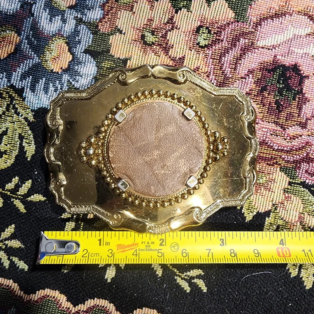 Vintage Metal Belt Buckle, Brass, Round Token Holder, holding a piece of leather